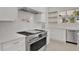 Close-up of the modern kitchen with stainless steel appliances, quartz countertops, and stylish fixtures at 409 W 2Nd Ave, Windermere, FL 34786
