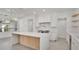 Elegant white kitchen with quartz countertops, a large island, and modern appliances at 409 W 2Nd Ave, Windermere, FL 34786