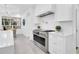 Gourmet kitchen featuring stainless steel appliances, white cabinetry, and a modern range hood at 409 W 2Nd Ave, Windermere, FL 34786
