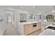Open kitchen with a large island, stainless steel refrigerator, and adjacent dining area at 409 W 2Nd Ave, Windermere, FL 34786
