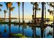 Lakefront property with dock, boathouse and tranquil water reflecting trees and sky at 409 W 2Nd Ave, Windermere, FL 34786