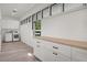 Contemporary laundry room featuring a front-load washer/dryer, ample storage, and natural light at 409 W 2Nd Ave, Windermere, FL 34786