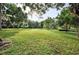 Expansive green lawn area with mature trees and landscaping offering ample space for recreation at 409 W 2Nd Ave, Windermere, FL 34786