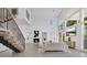 Open-concept living room with high ceilings, fireplace, and a staircase leading to a second floor at 409 W 2Nd Ave, Windermere, FL 34786