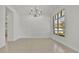 Minimalist living room with modern chandelier and a large window offering ample natural light at 409 W 2Nd Ave, Windermere, FL 34786