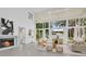 Bright living room features a fireplace, high ceilings, and large windows overlooking the pool at 409 W 2Nd Ave, Windermere, FL 34786