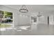 Bright living space with stylish chandeliers, large windows, and a clean, modern design at 409 W 2Nd Ave, Windermere, FL 34786
