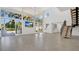 Bright, spacious living room with tall windows, tile floors, and open staircase at 409 W 2Nd Ave, Windermere, FL 34786