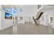 Bright, open living area with staircase, large windows, and a seamless flow throughout at 409 W 2Nd Ave, Windermere, FL 34786