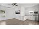 Open-concept living space with hardwood floors, a wall-mounted TV, and a modern kitchen at 409 W 2Nd Ave, Windermere, FL 34786