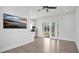 Bright living space featuring hardwood floors, a wall-mounted TV, and a modern kitchen at 409 W 2Nd Ave, Windermere, FL 34786