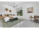 Bright and airy main bedroom featuring a large window, modern chandelier, and neutral decor at 409 W 2Nd Ave, Windermere, FL 34786