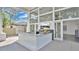 Covered outdoor kitchen with a built-in grill, countertop bar, and expansive glass doors to the indoors at 409 W 2Nd Ave, Windermere, FL 34786