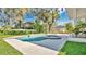 Relaxing pool area with jacuzzi, lush landscaping, and a clear blue sky at 409 W 2Nd Ave, Windermere, FL 34786