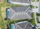 Drone shot of a home highlighting the screened pool area, lawn, and overall property layout at 418 Marcello Blvd, Kissimmee, FL 34746