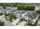 Beautiful neighborhood aerial featuring a two-story gray-roofed home, complemented by lush landscaping and a double driveway at 418 Marcello Blvd, Kissimmee, FL 34746