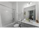 This is a well-lit bathroom with a shower-tub combo and vanity at 418 Marcello Blvd, Kissimmee, FL 34746