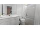 Clean bathroom featuring a white single sink vanity, toilet, and a shower-tub combo for convenience at 418 Marcello Blvd, Kissimmee, FL 34746