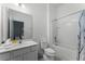 Well-lit bathroom featuring a shower-tub combo and a single sink vanity with ample counter space at 418 Marcello Blvd, Kissimmee, FL 34746
