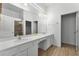 Bathroom featuring double sinks, a large mirror and walk-in shower at 418 Marcello Blvd, Kissimmee, FL 34746