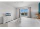Cozy bedroom featuring a bed, dresser with TV and a sunny window with beautiful outside views at 418 Marcello Blvd, Kissimmee, FL 34746