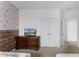 Charming bedroom featuring a dresser, access to the hallway, and princess themed wallpaper at 418 Marcello Blvd, Kissimmee, FL 34746