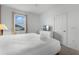 Bright bedroom featuring a queen bed with a large window and white dresser with TV, inviting space at 418 Marcello Blvd, Kissimmee, FL 34746