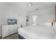 Light bedroom offering a queen bed, neutral walls and white dresser with TV creating comfortable area at 418 Marcello Blvd, Kissimmee, FL 34746