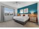 Comfortable bedroom with a large window providing natural light, complemented by stylish furnishings at 418 Marcello Blvd, Kissimmee, FL 34746