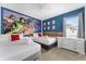 Spacious bedroom featuring two beds, a dresser, and a comic book themed wall art at 418 Marcello Blvd, Kissimmee, FL 34746