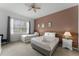 Cozy bedroom with two beds, soft carpeting, and warm, inviting decor at 418 Marcello Blvd, Kissimmee, FL 34746