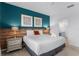 Stylish bedroom with a blue accent wall, offering a comfortable bed and well-lit bedside tables at 418 Marcello Blvd, Kissimmee, FL 34746