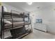 The bedroom featuring triple bunkbeds, a dresser and tv for entertainment at 418 Marcello Blvd, Kissimmee, FL 34746