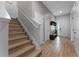 Inviting foyer with hardwood flooring and a staircase to the upper level at 418 Marcello Blvd, Kissimmee, FL 34746