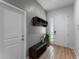 Welcoming foyer with light wood-look floors, storage bench, and coat rack at 418 Marcello Blvd, Kissimmee, FL 34746