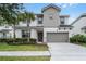 Charming two-story home with a two-car garage and well-maintained landscaping at 418 Marcello Blvd, Kissimmee, FL 34746