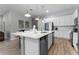 Bright kitchen with white cabinetry, stainless steel appliances and a large island at 418 Marcello Blvd, Kissimmee, FL 34746