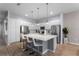Bright kitchen boasts stainless steel appliances, white cabinets, and a large island at 418 Marcello Blvd, Kissimmee, FL 34746