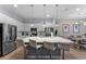 Modern kitchen featuring a large island with seating, stainless steel appliances at 418 Marcello Blvd, Kissimmee, FL 34746