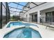 View of screened-in pool and spa area, connected to the home's patio, creating a private backyard oasis perfect for relaxation at 418 Marcello Blvd, Kissimmee, FL 34746