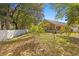 Spacious backyard featuring mature trees and a fenced perimeter at 4424 Park Eden Cir, Orlando, FL 32810