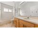 Bathroom with a bathtub, wooden vanity, and a brightly lit mirror at 4424 Park Eden Cir, Orlando, FL 32810