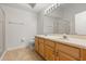 Bathroom featuring double sinks, wooden cabinetry, and a glass shower at 4424 Park Eden Cir, Orlando, FL 32810