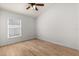 Neutral bedroom with a window and light wood-look floors at 4424 Park Eden Cir, Orlando, FL 32810