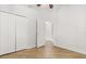 Spacious bedroom with wood-look floors, closet, and doorway at 4424 Park Eden Cir, Orlando, FL 32810