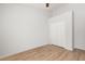A clean, minimalist bedroom with wood-look flooring and a double door closet at 4424 Park Eden Cir, Orlando, FL 32810
