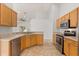 Well-lit kitchen featuring wood cabinets, stainless steel appliances, and tile flooring at 4424 Park Eden Cir, Orlando, FL 32810