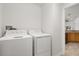 Clean laundry room with a white washer and dryer next to a doorway at 4424 Park Eden Cir, Orlando, FL 32810