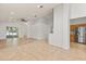 Open-concept living room with tile flooring and a view to kitchen and screened lanai at 4424 Park Eden Cir, Orlando, FL 32810