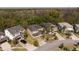 Aerial view of several two-story homes, showcasing the well-maintained lawns, driveways, and proximity to wooded areas at 4561 Cabello Loop, Kissimmee, FL 34746